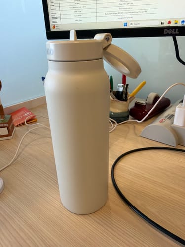 Customer's insulated water bottle on their work desk, Ozzi mixed in for the day.
